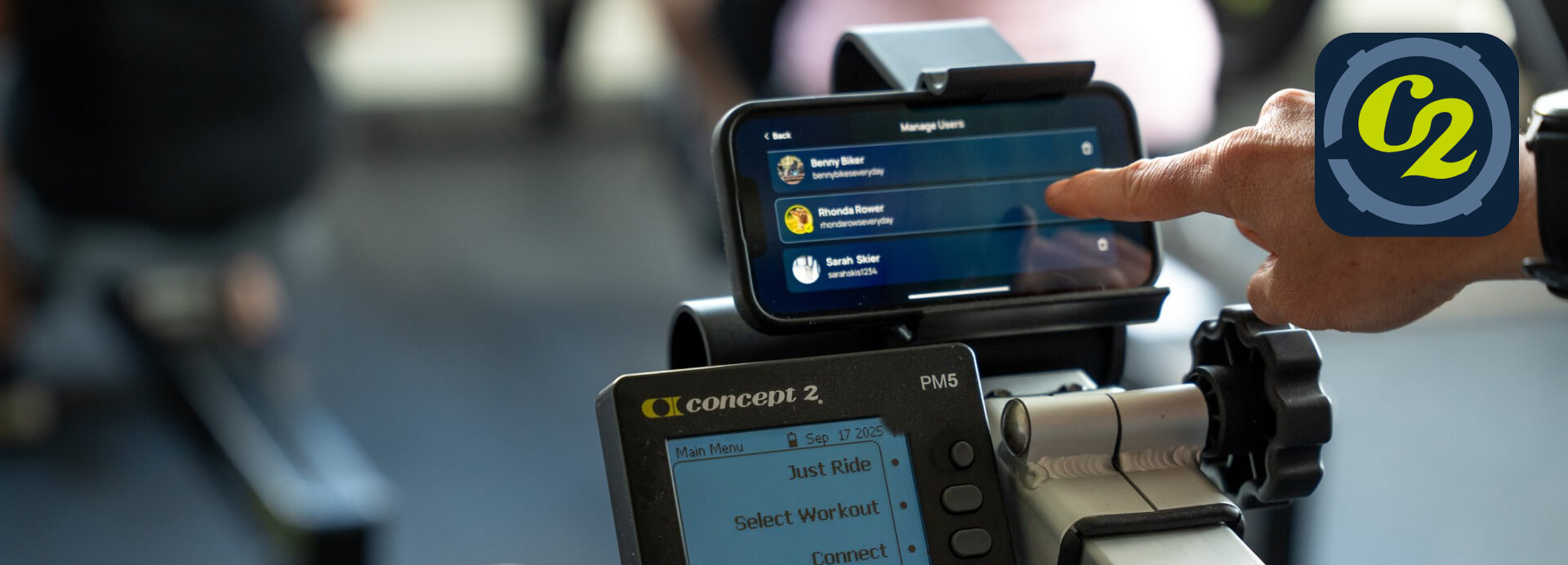 Concept2 ErgData app on a smartphone mounted above a PM5 Performance Monitor