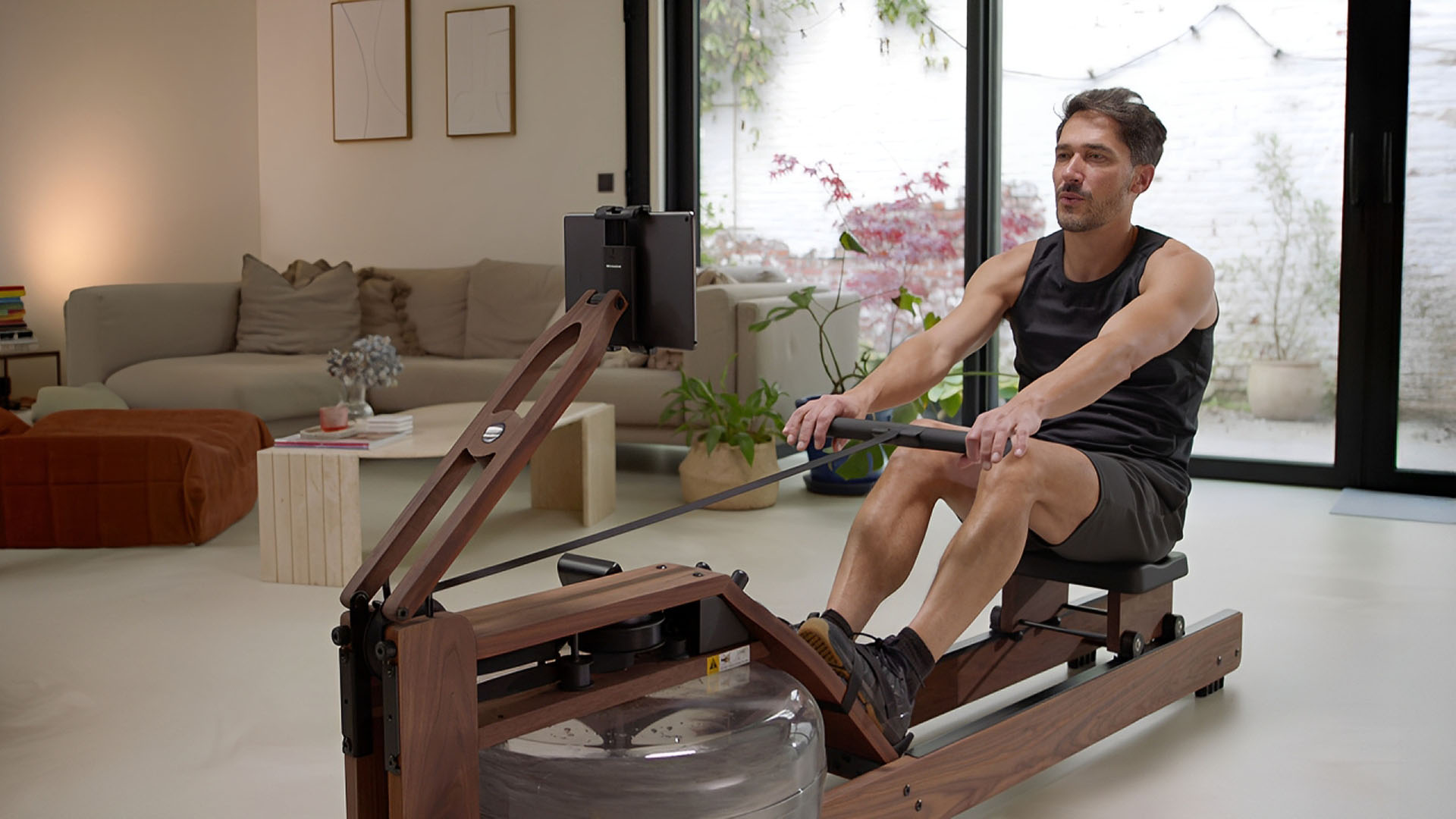 Man rowing on a WaterRower with EXR