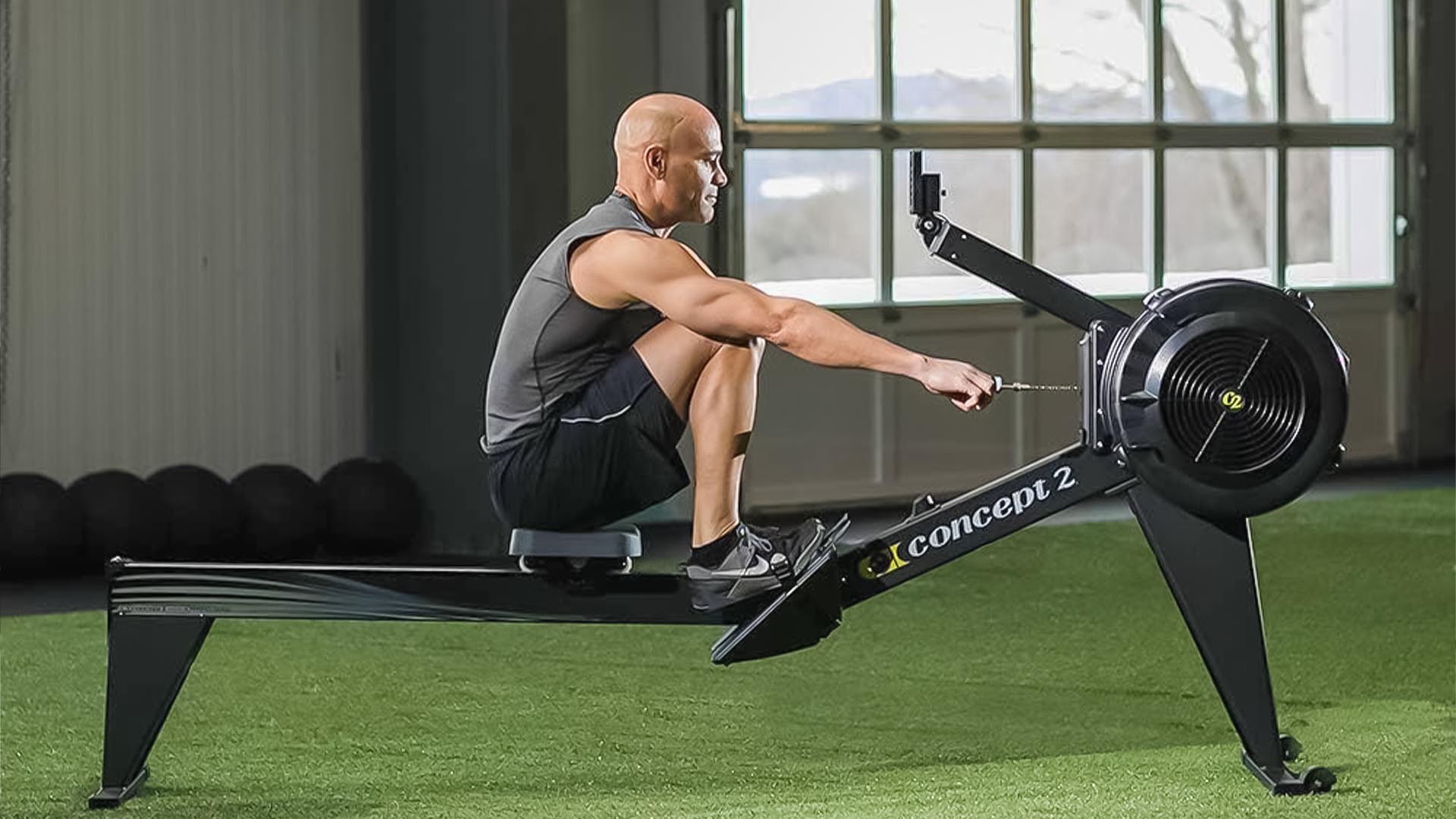 Man rowing on Concept2 rowing machine.