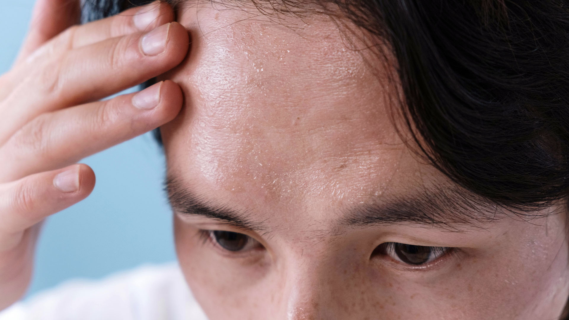 Man with sweat on forehead.