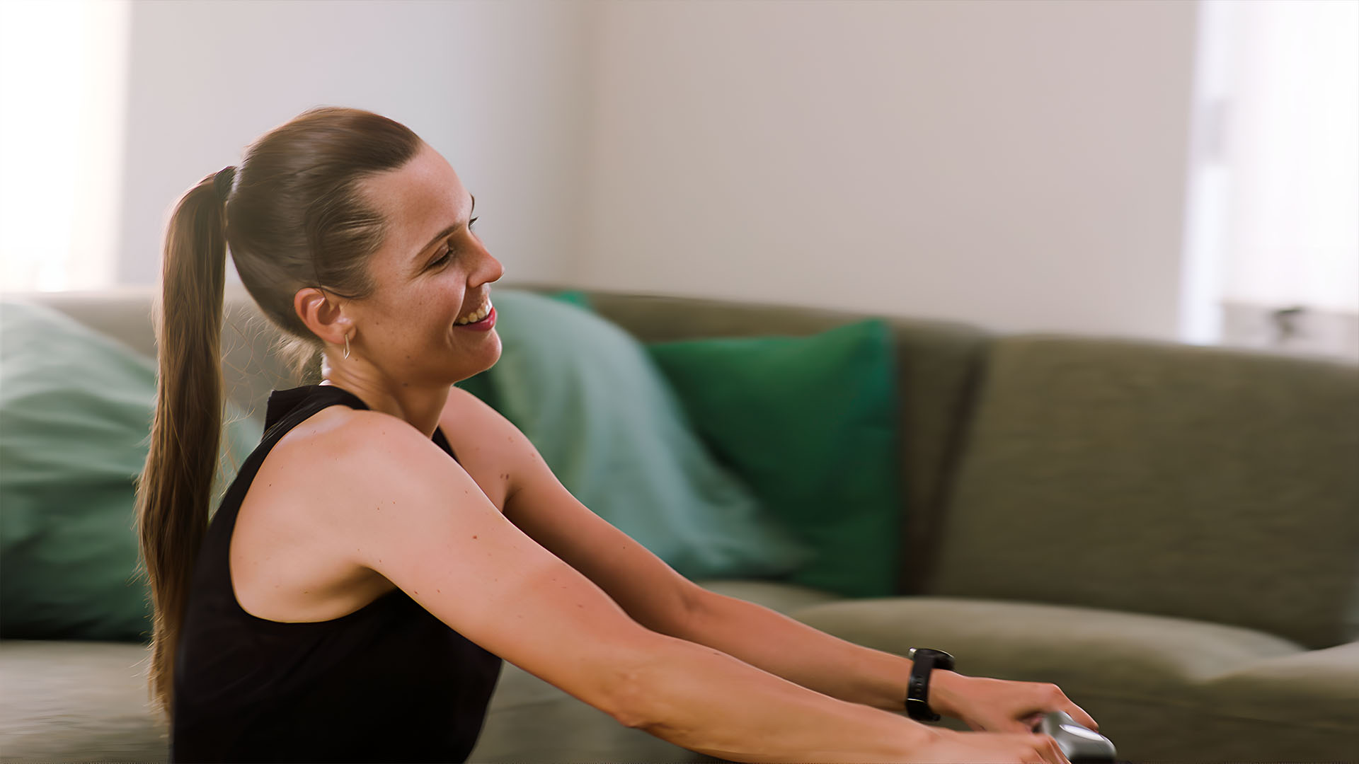 Woman smiling while training on the rowing machine.