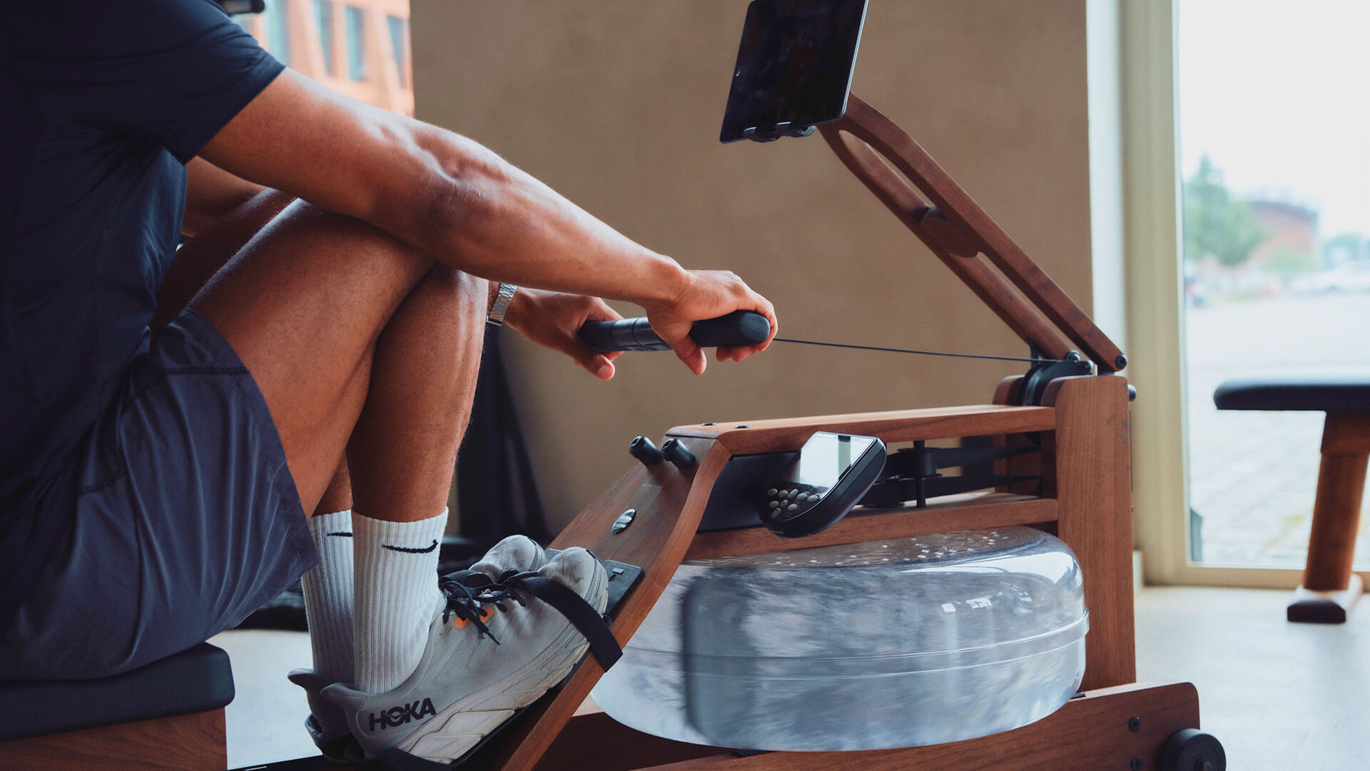 Close-up of correct indoor rowing technique, showing the legs driving and the back held straight