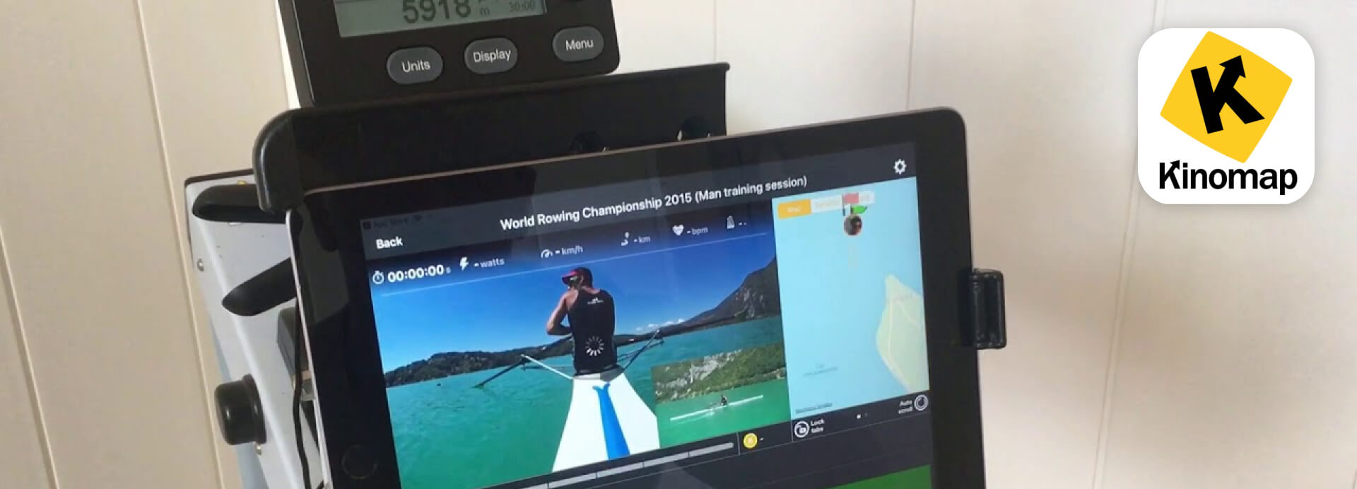 Kinomap rowing app displaying a real-world scenic rowing video on a tablet connected to a rowing machine