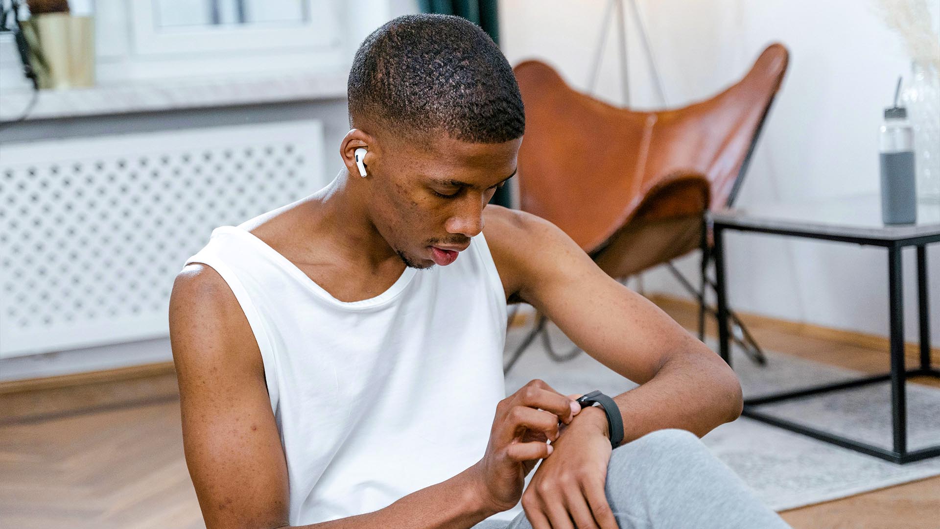 Man looking at his smartwatch to track his heart rate during a workout.