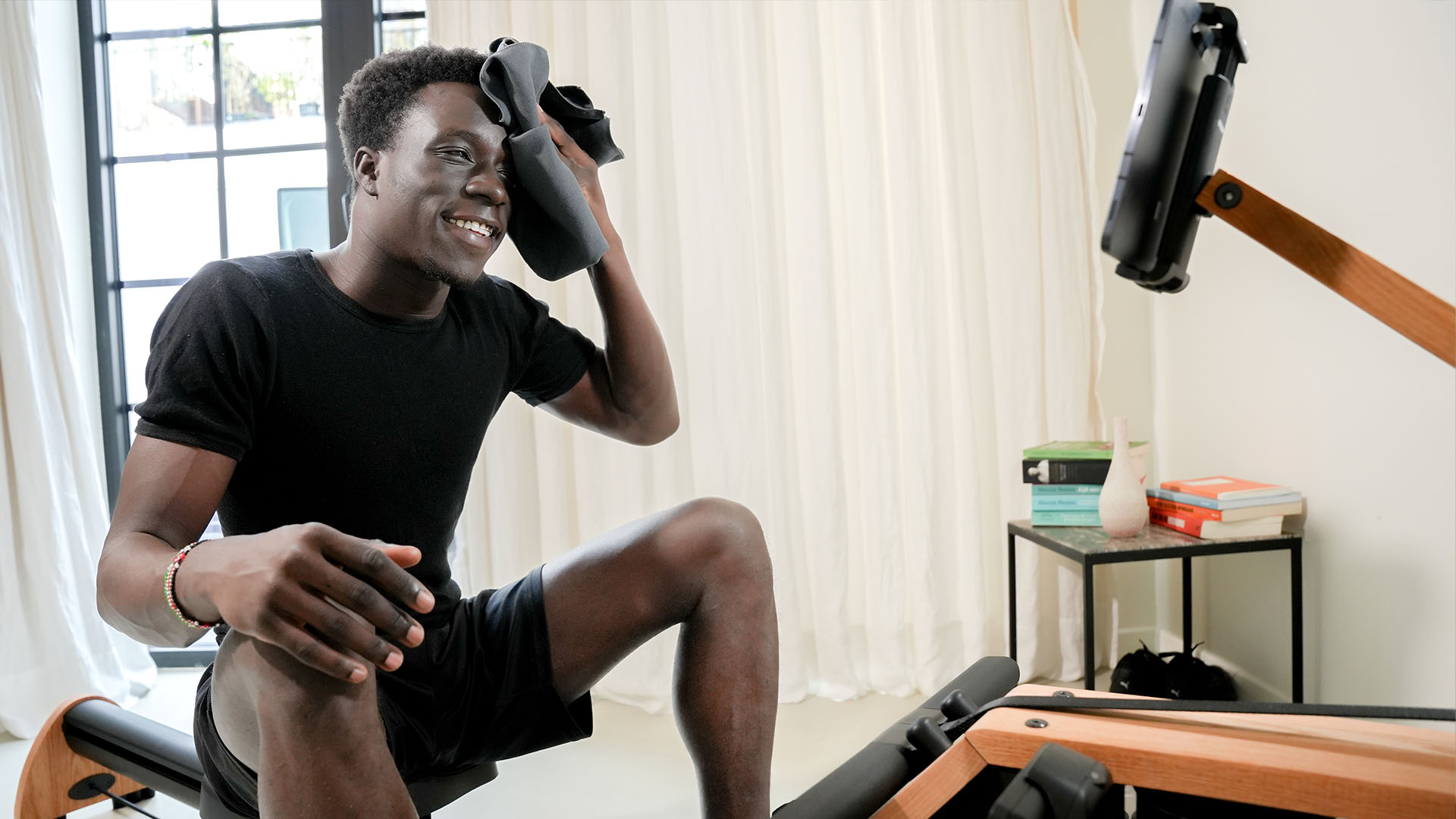 man cleaning face on waterrower
