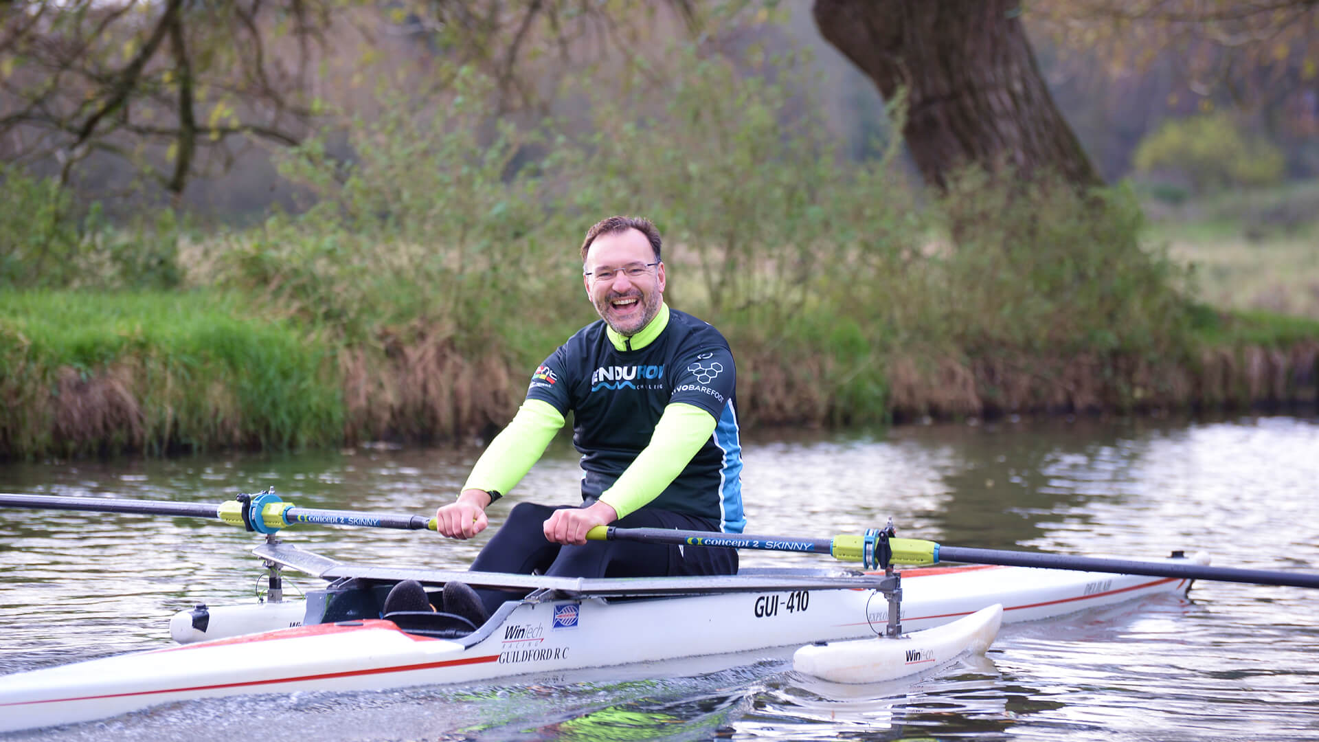 A man rowing in an adaptive single scull.