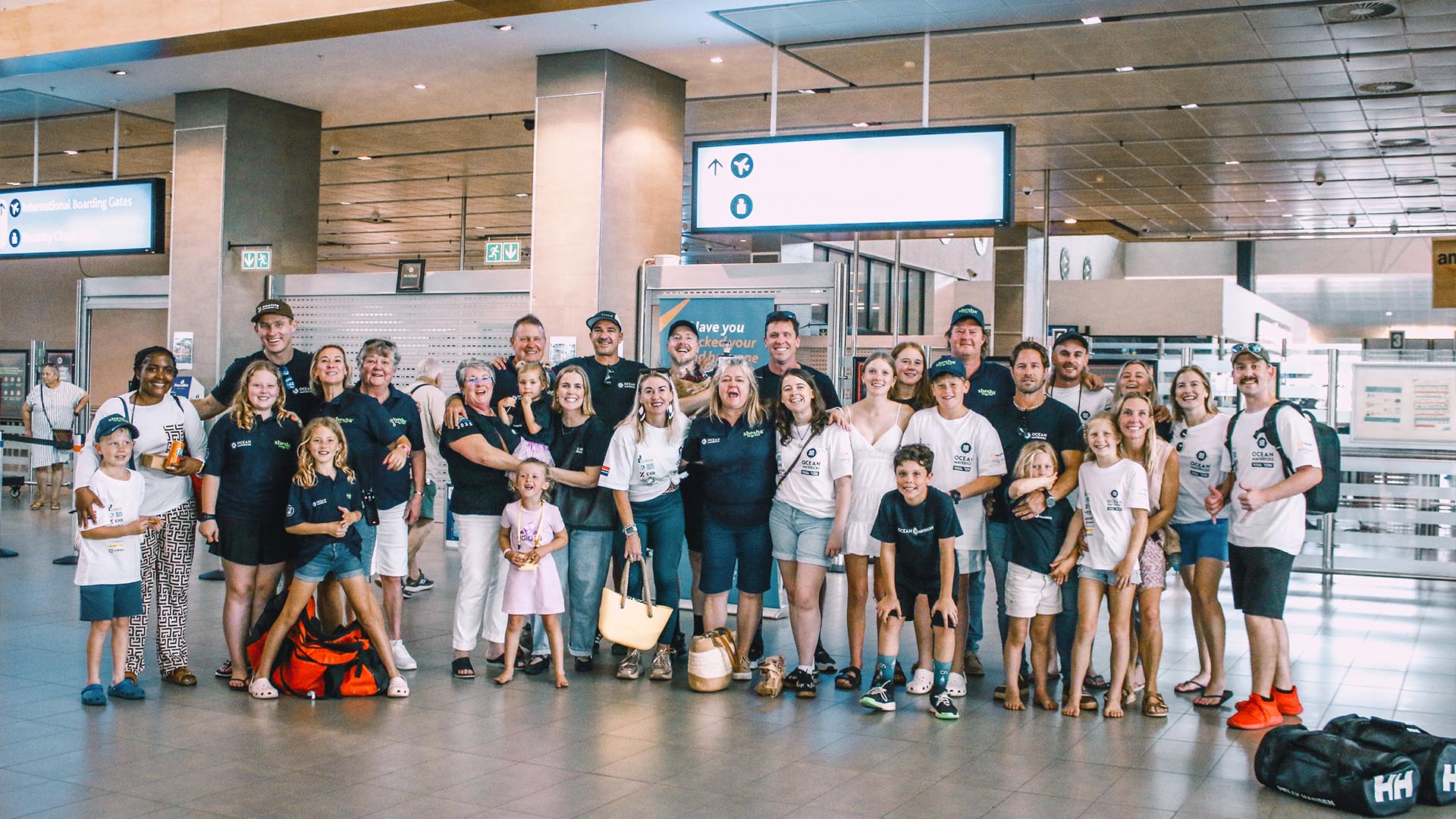 Team Ocean Mavericks at the airport surrounded with friends and family.