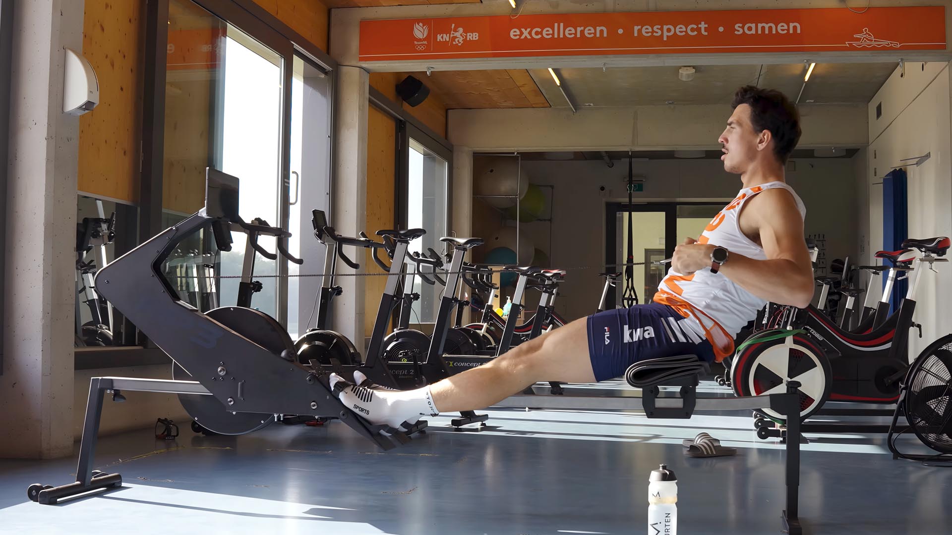 Niki van Sprang training on the RP3 indoor rowing machine in an empty gym.