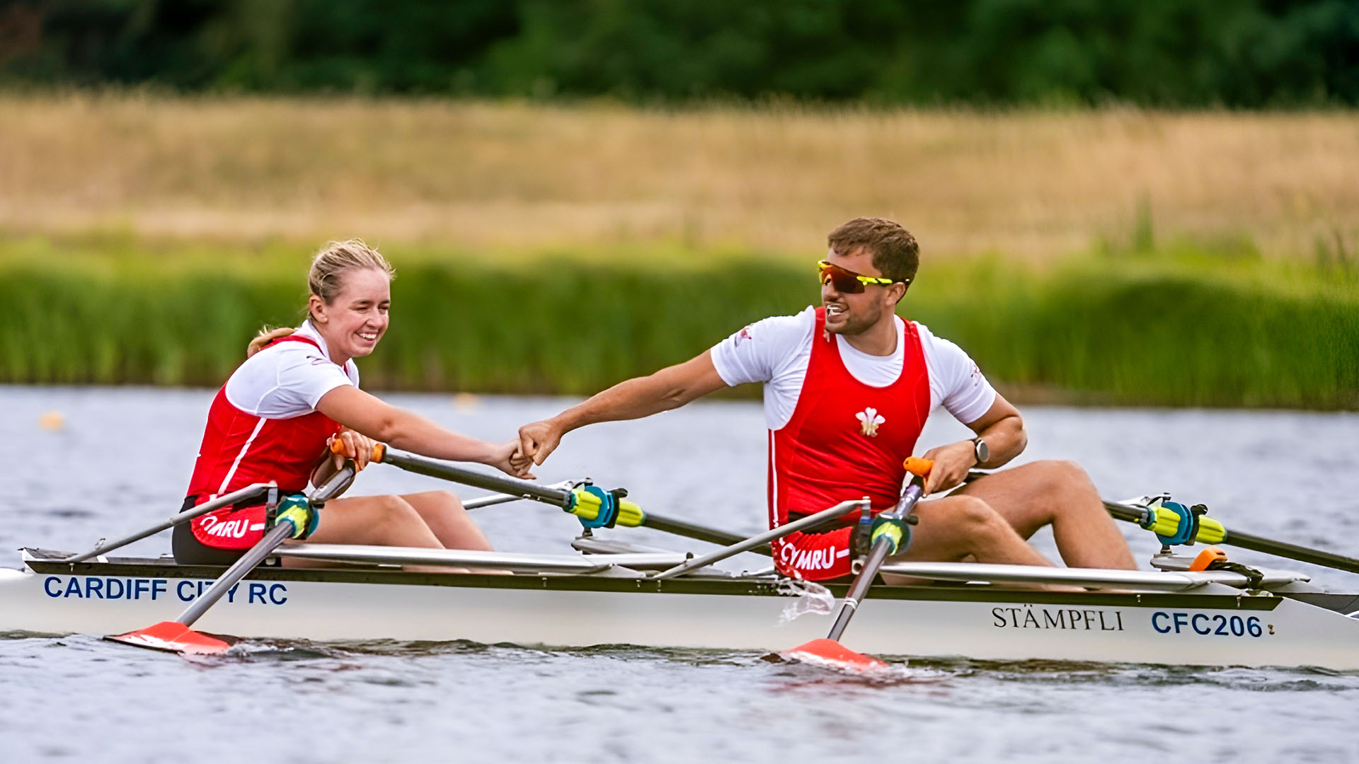Rebekah and Miguel in a double boat celebrating their victory on the water.