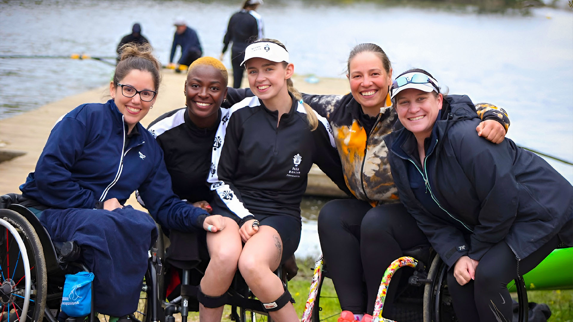Group photo of five smiling para athletes at the pontoon at the PRF training camp in Portugal.