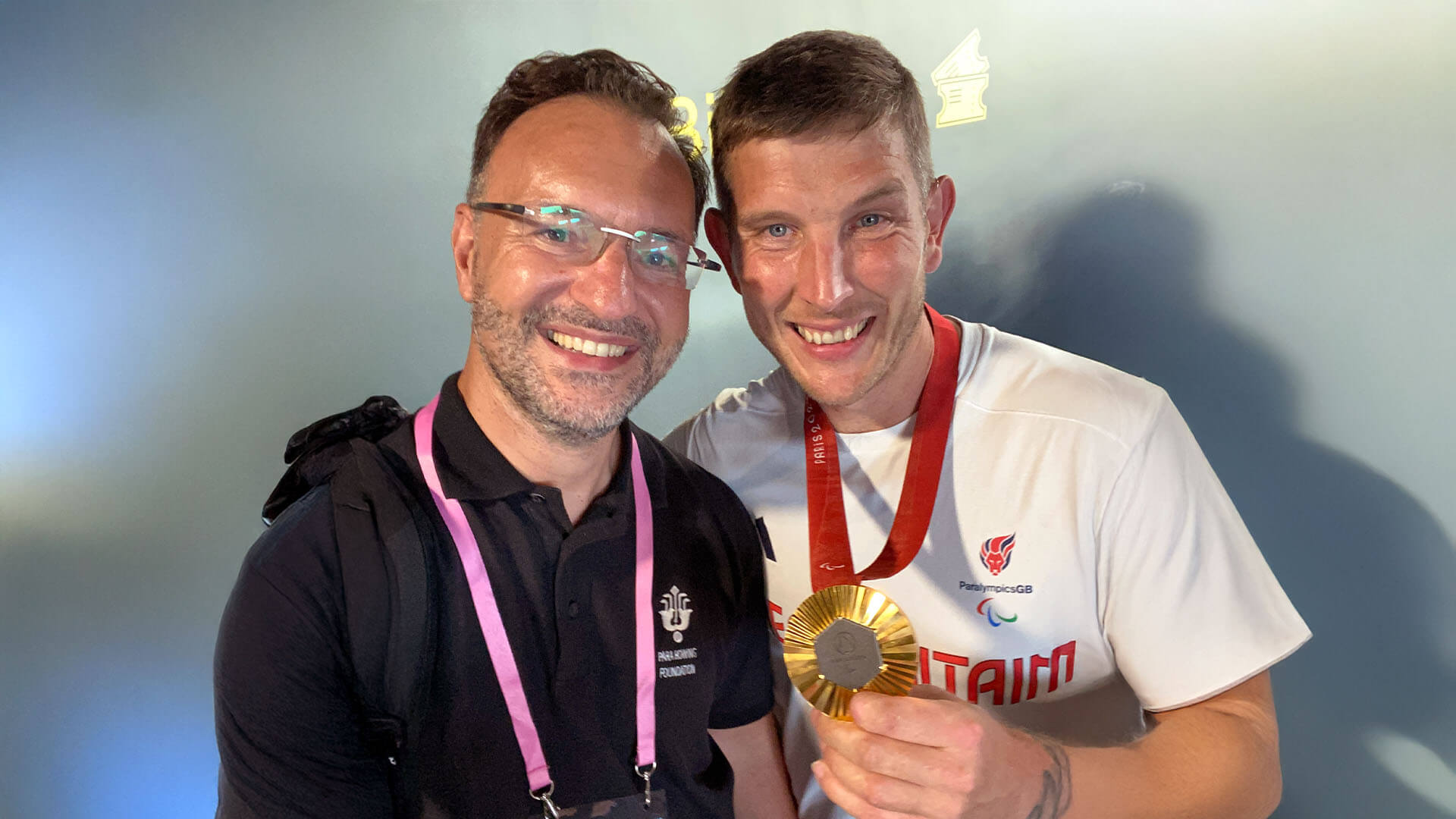 Steven Dowd and Paralympian Gregg Stevenson posing for the camera with his gold medal. 