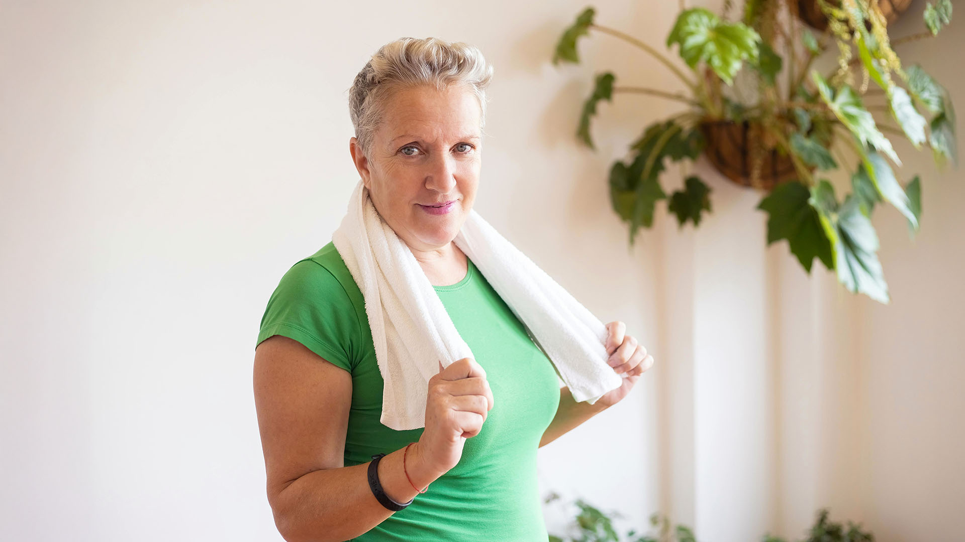 Woman in green shirt about to start her workout