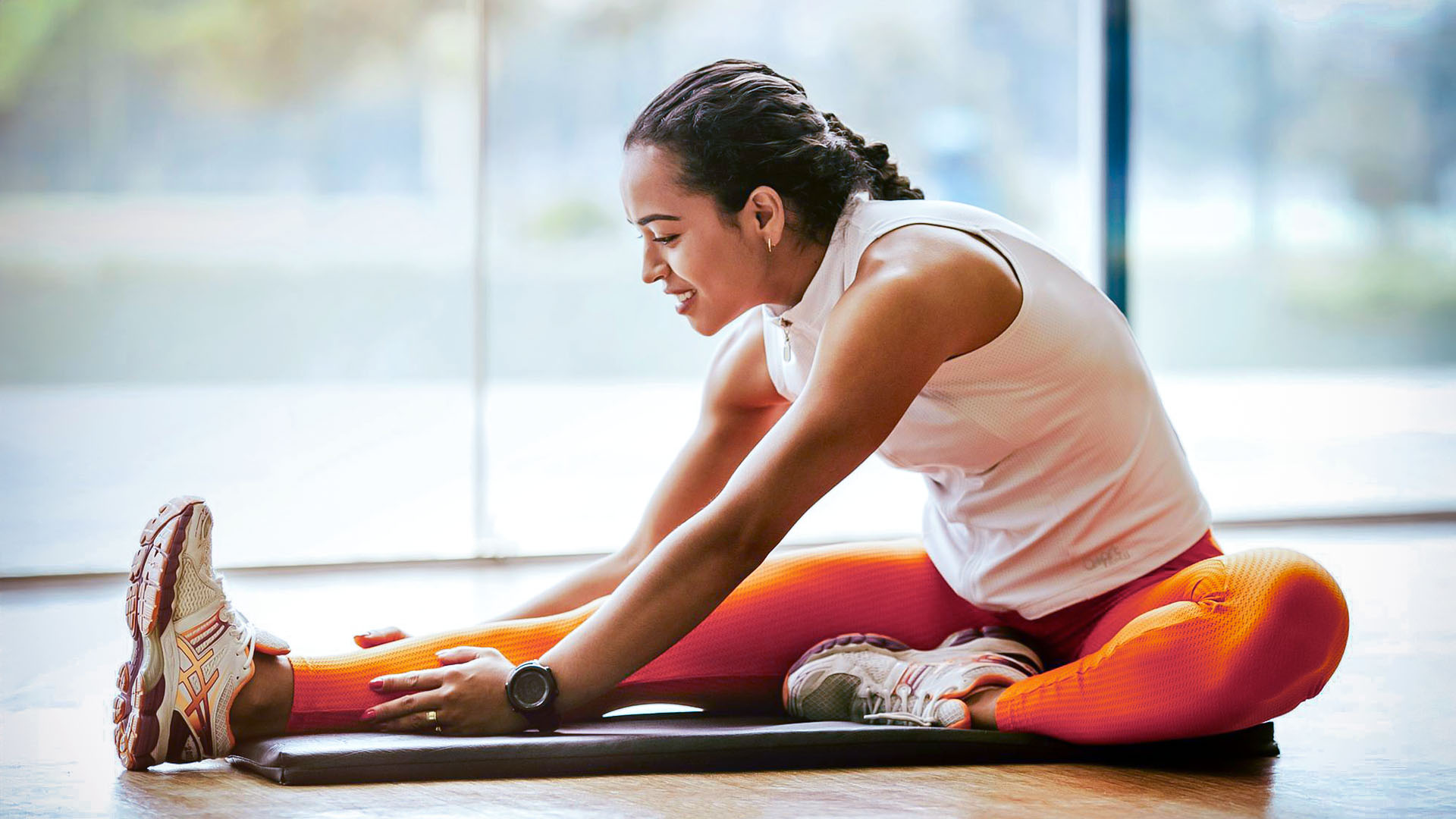 Woman stretching on yoga mat